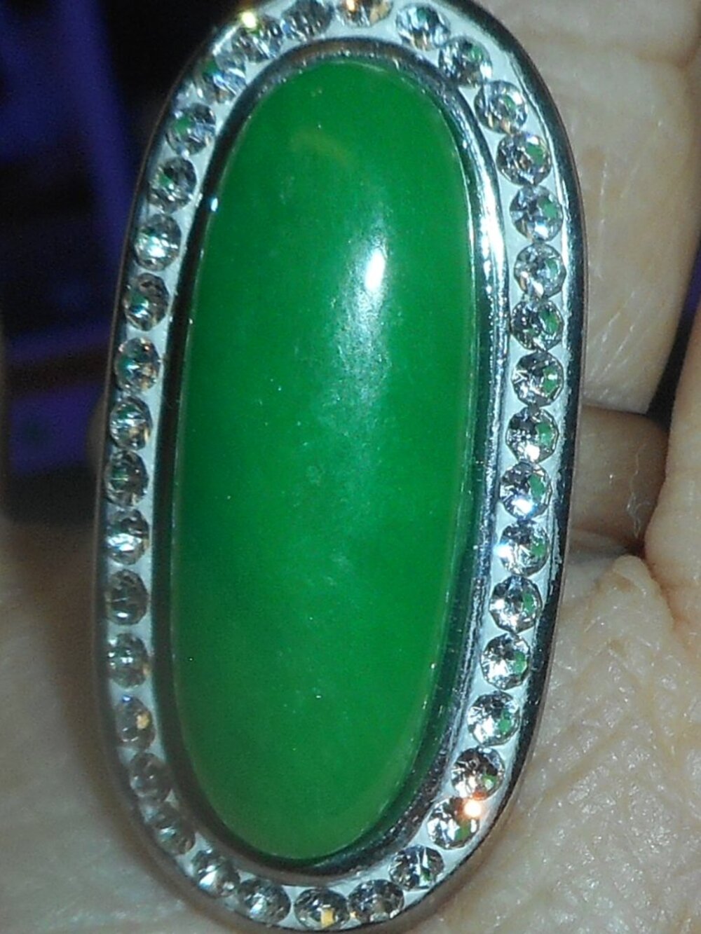 long green stone w/white stones around, plain silver band, - size is 10